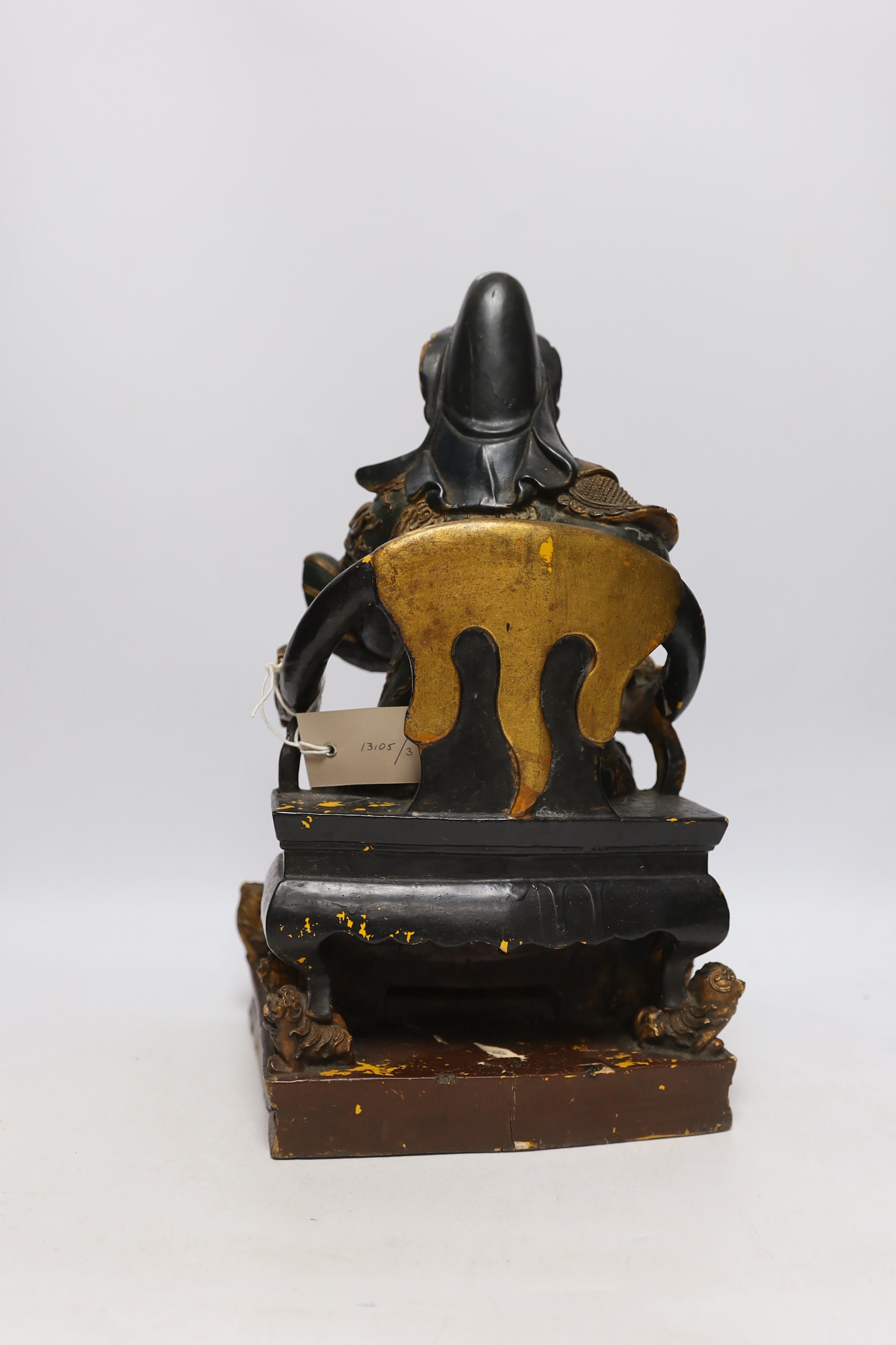 A 19th century Chinese polychrome wood and composition seated figure of Guandi, 41cm high